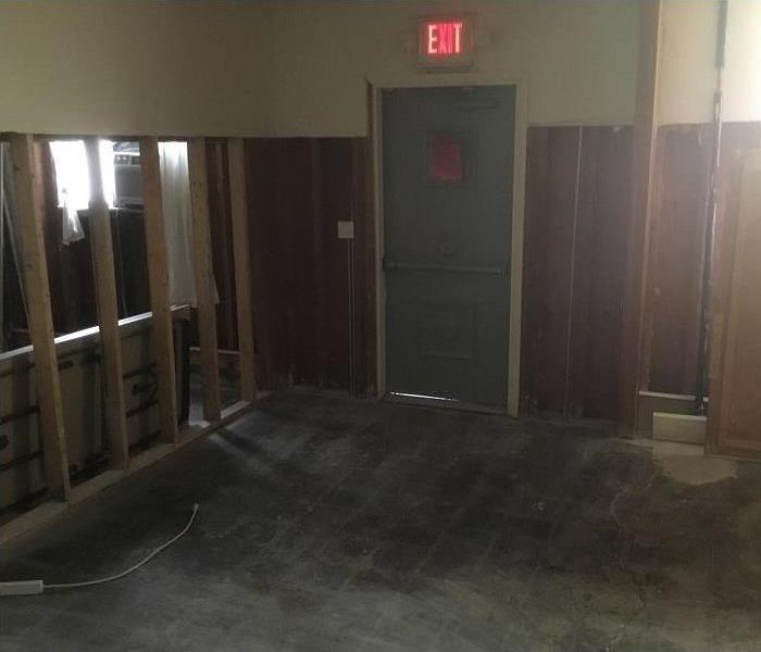 Room with flooring and portions of the drywall removed