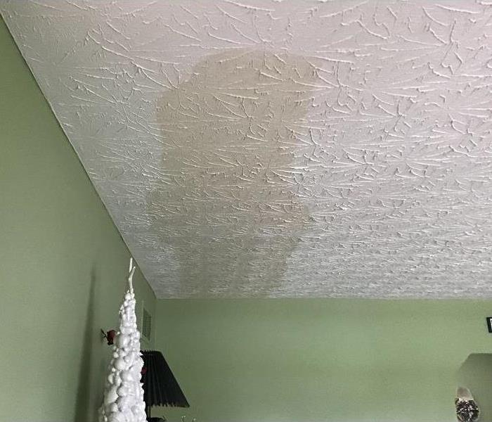 Ceiling of a home with large water stain.