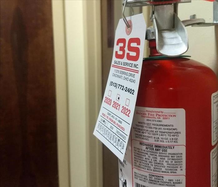 Fire Extinguisher Hanging on an office wall